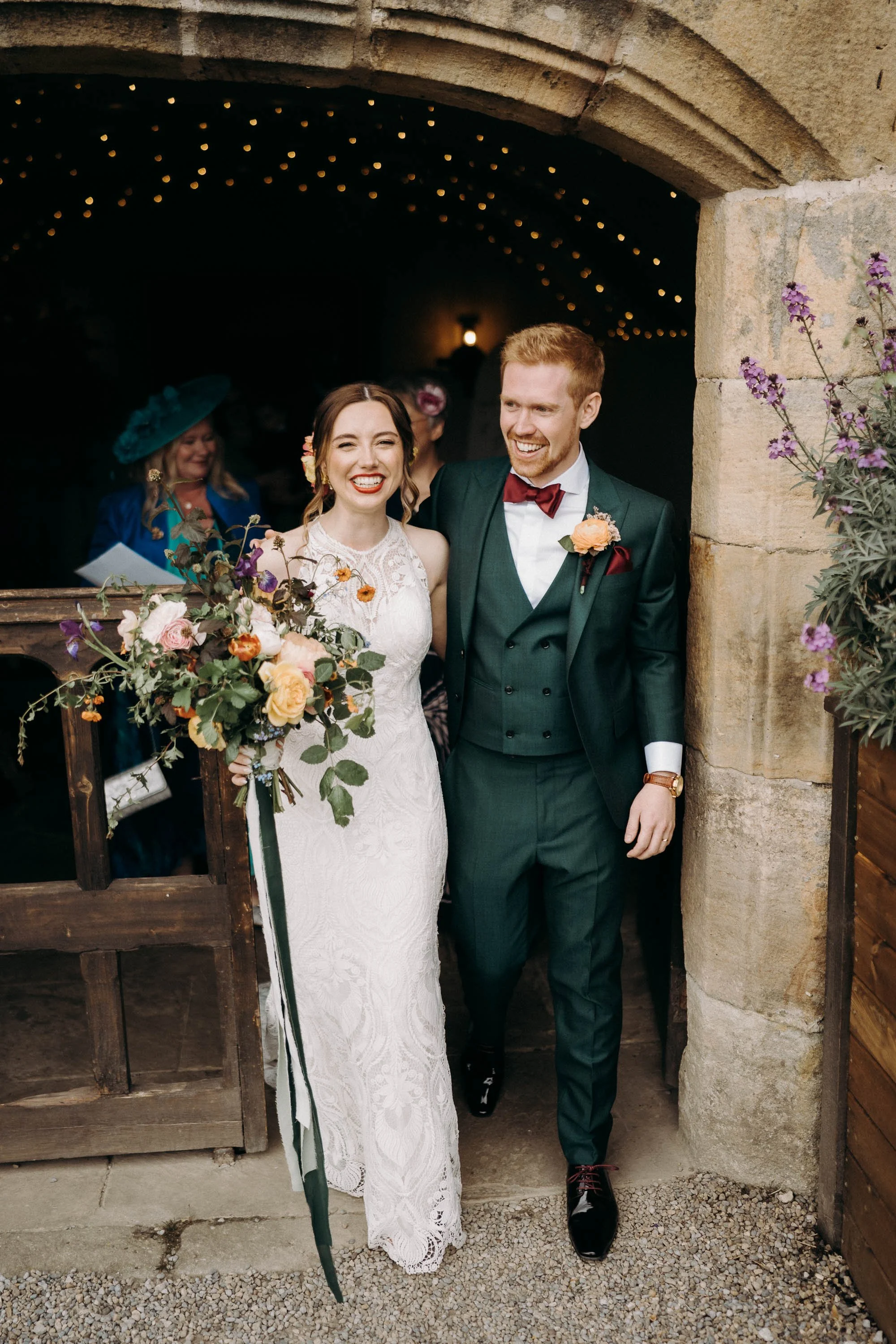 Bride and groom smiling as they walk out of their ceremony at The Priests House in Skipton.
