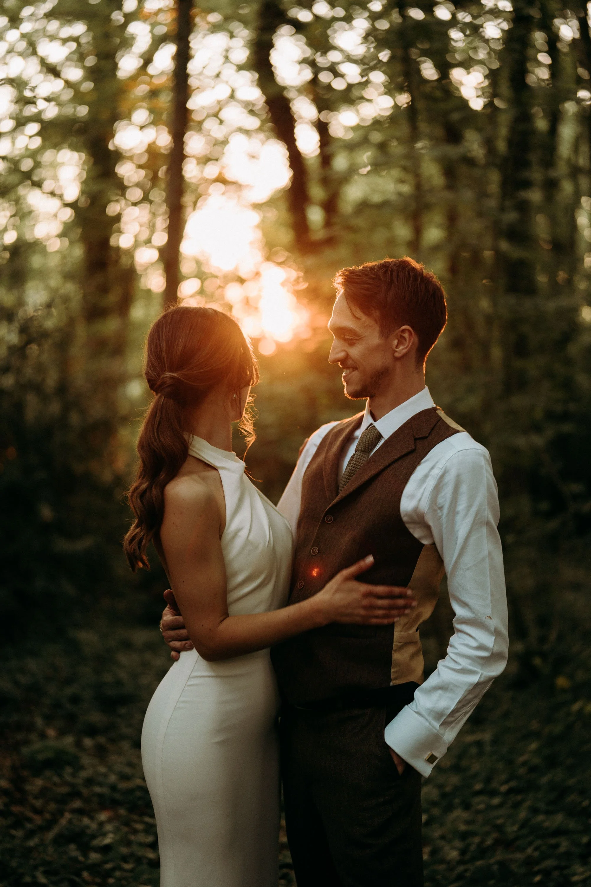 Bride and groom embracing in the forest at golden hour at Two Woods Estate.