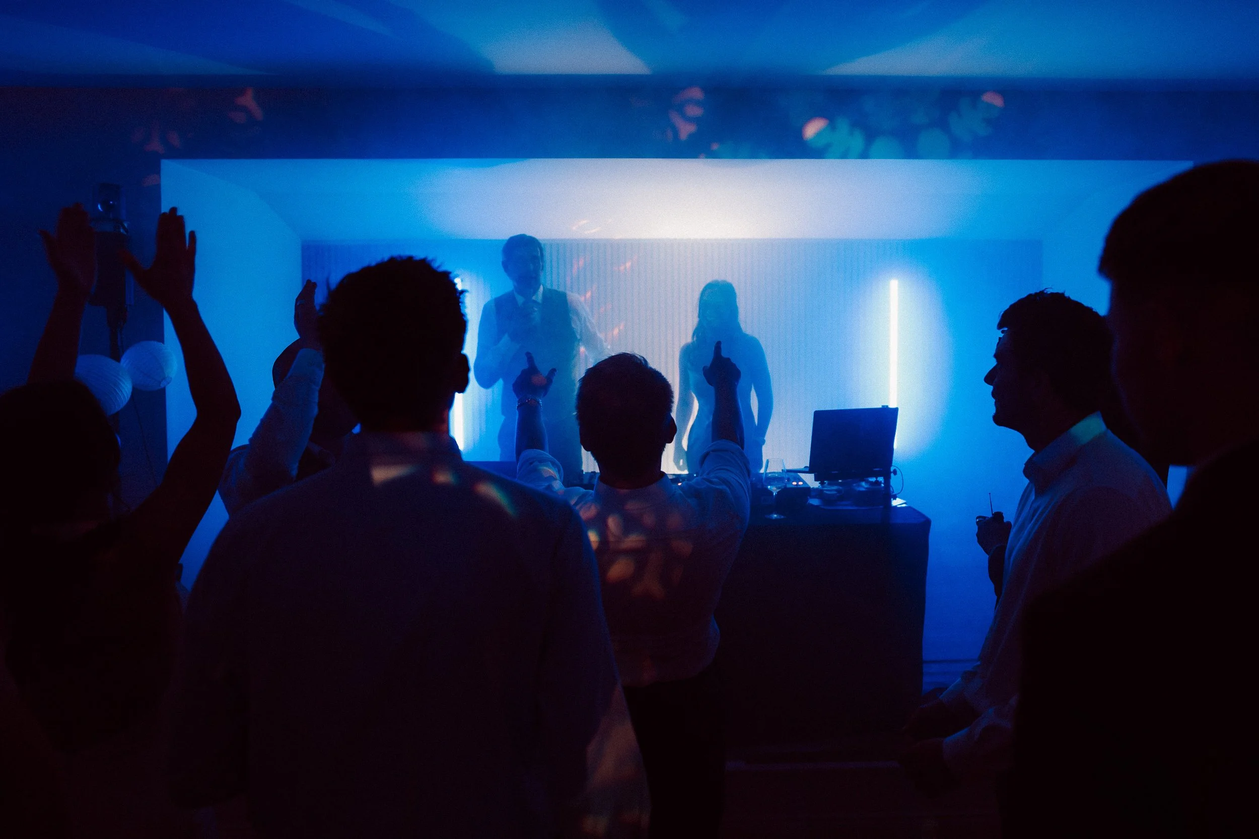 Silhouette of wedding guests dancing at Two Woods Estate.