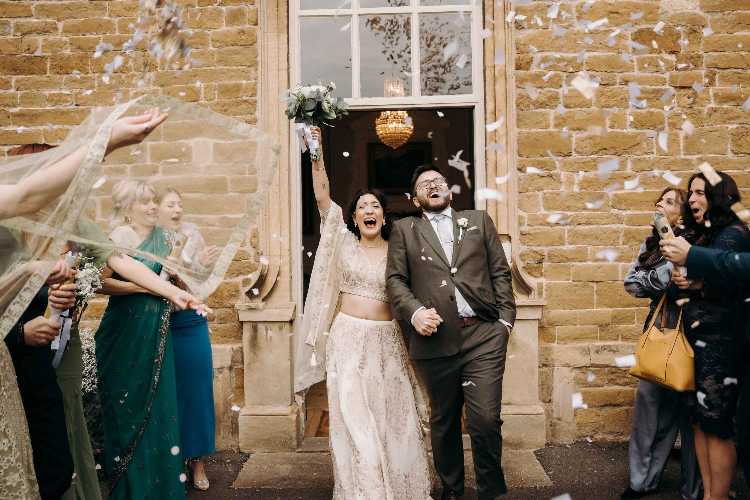 Bride and groom confetti moment at Brooksby Hall