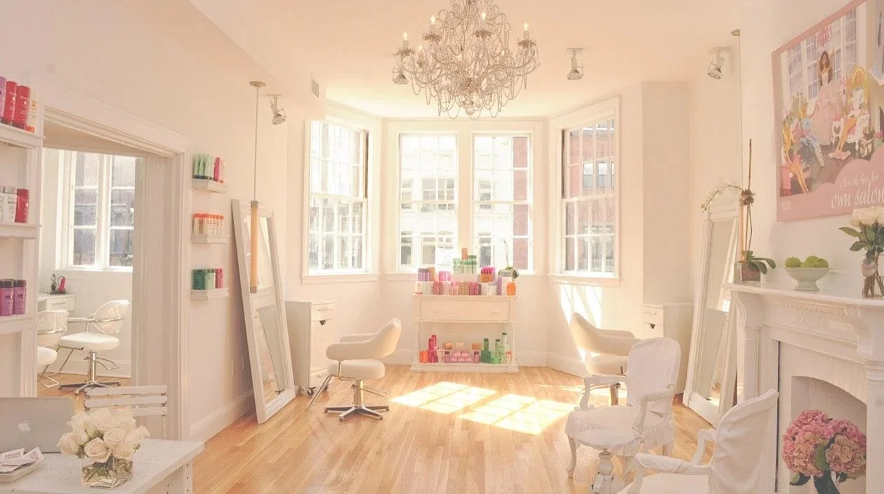 Beauty salon workspace with styling chairs and natural light