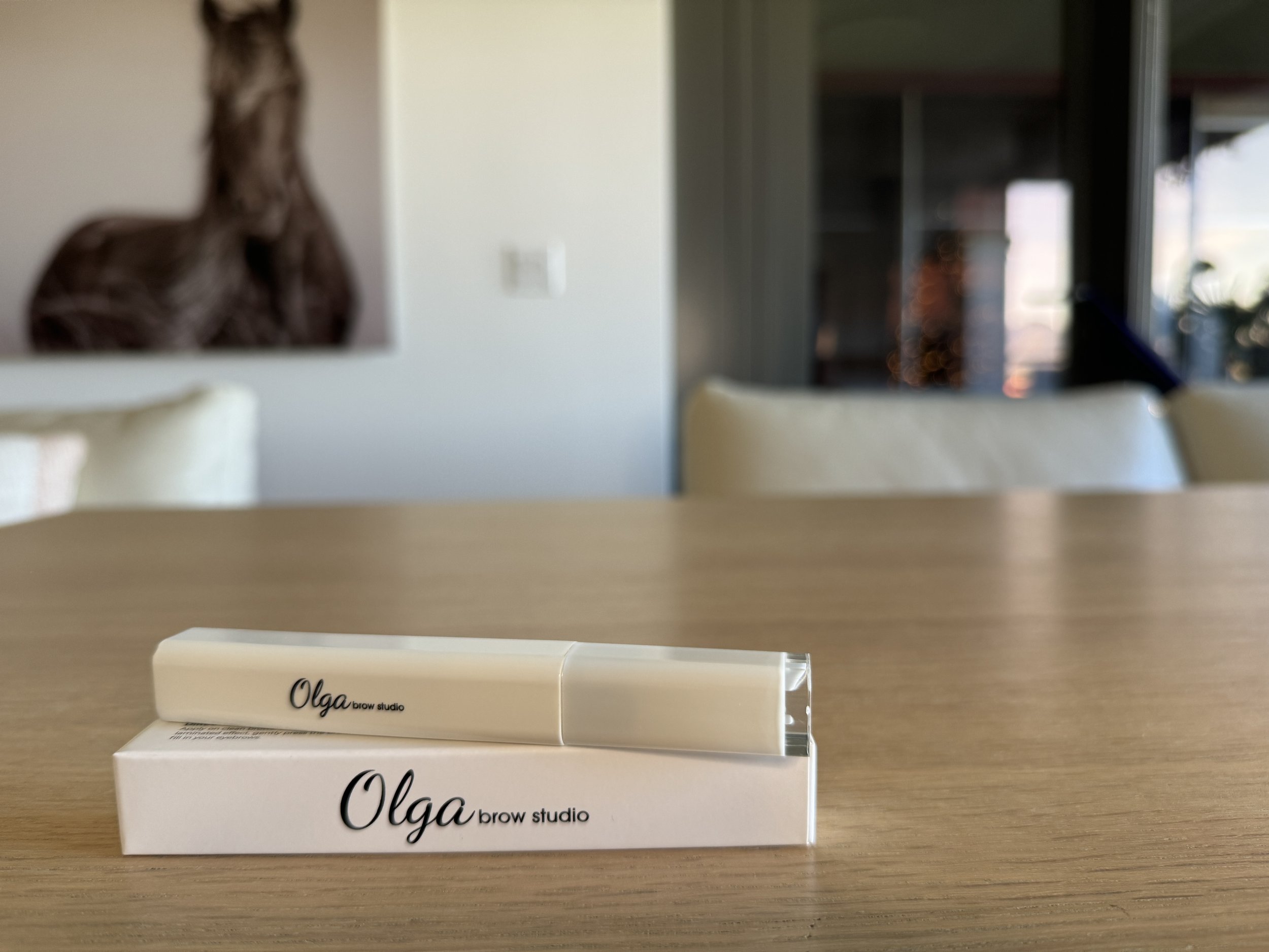 Best clean beauty brow gel displayed on wooden table