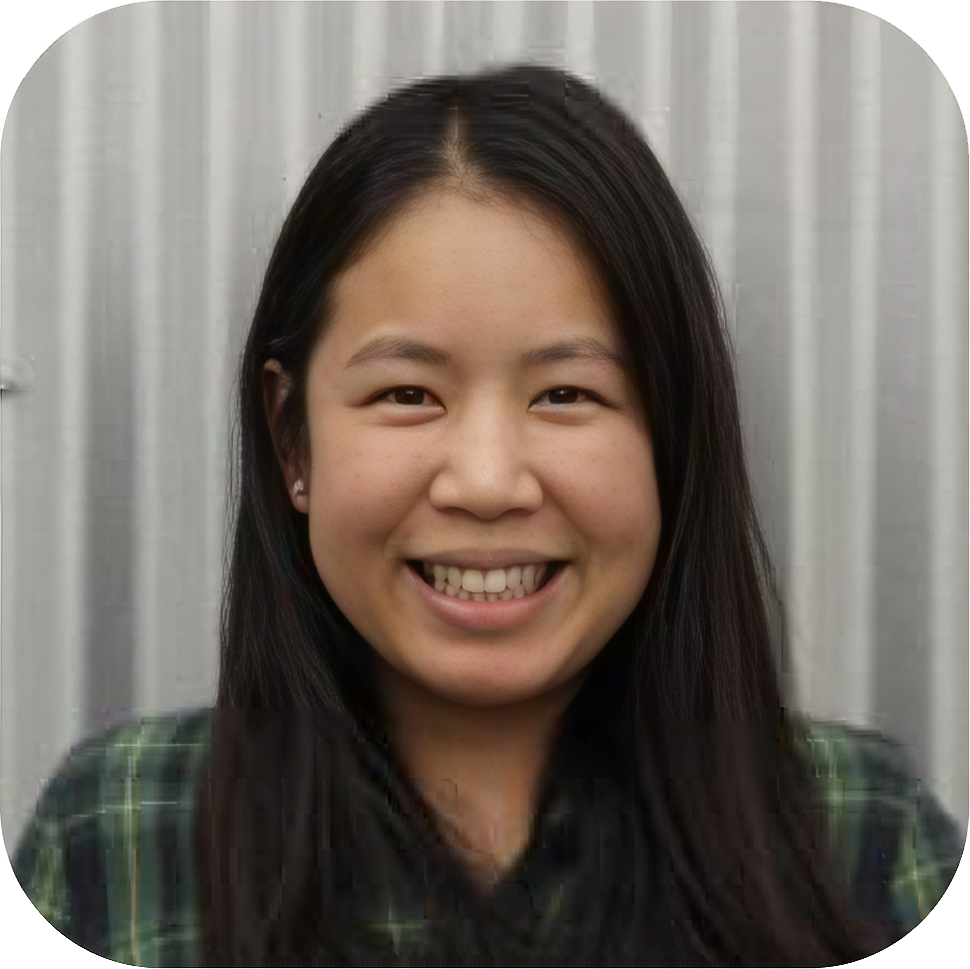 A young woman smiling in front of a metallic background.