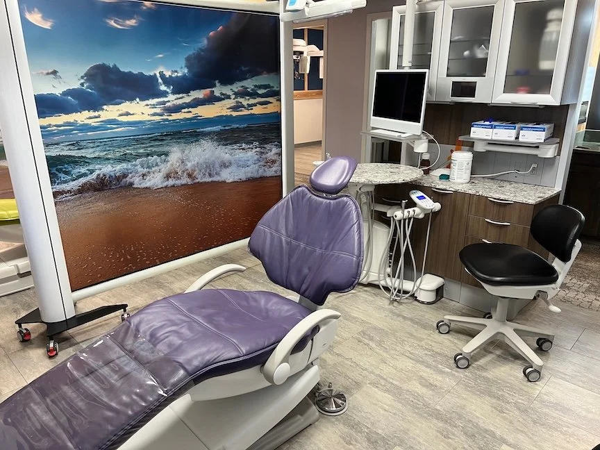 Photo of purple dental chair with beach and wave background screen