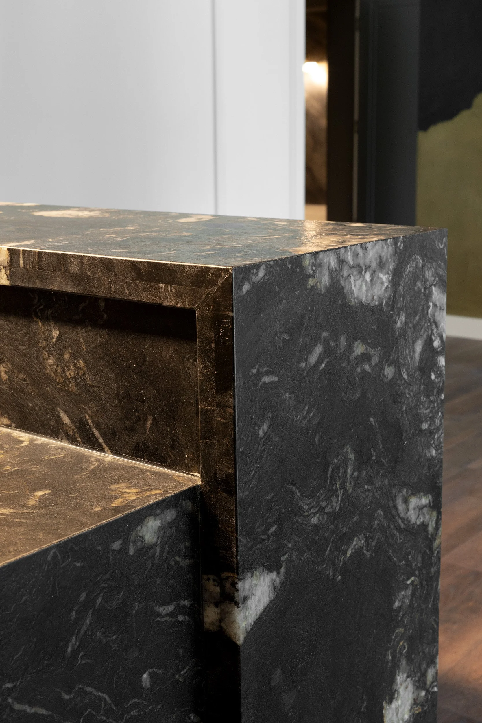 Close-up of a black and white marble countertop with a textured surface.
