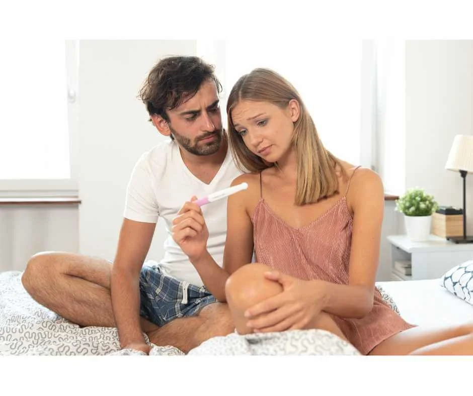 Couple reviewing a pregnancy test while exploring holistic and integrative support for male infertility