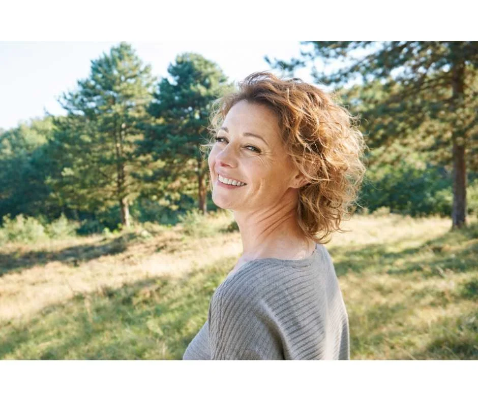 Midlife woman reflecting healthy aging, energy changes, and resilience over time