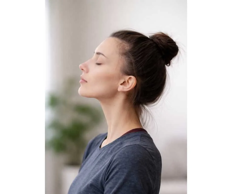 Woman practicing nasal breathing in profile to support airway function, oral health, nitric oxide production, and sleep regulation