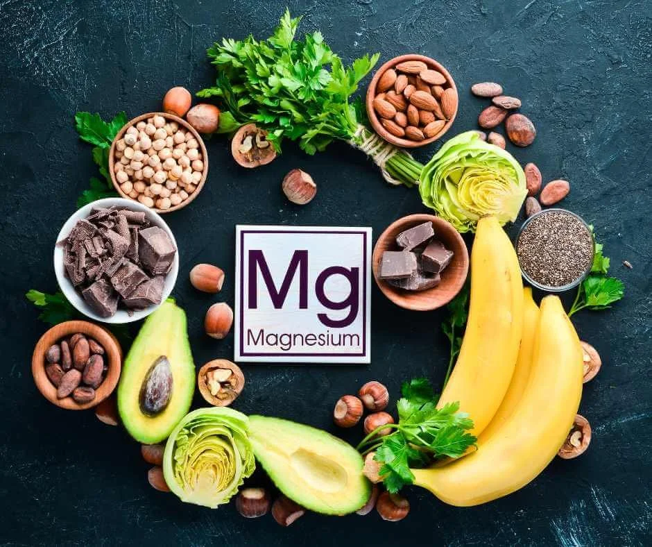 Magnesium-rich foods surrounding the Mg symbol, illustrating magnesium’s role in energy production, nervous system regulation, hormone balance, and detoxification