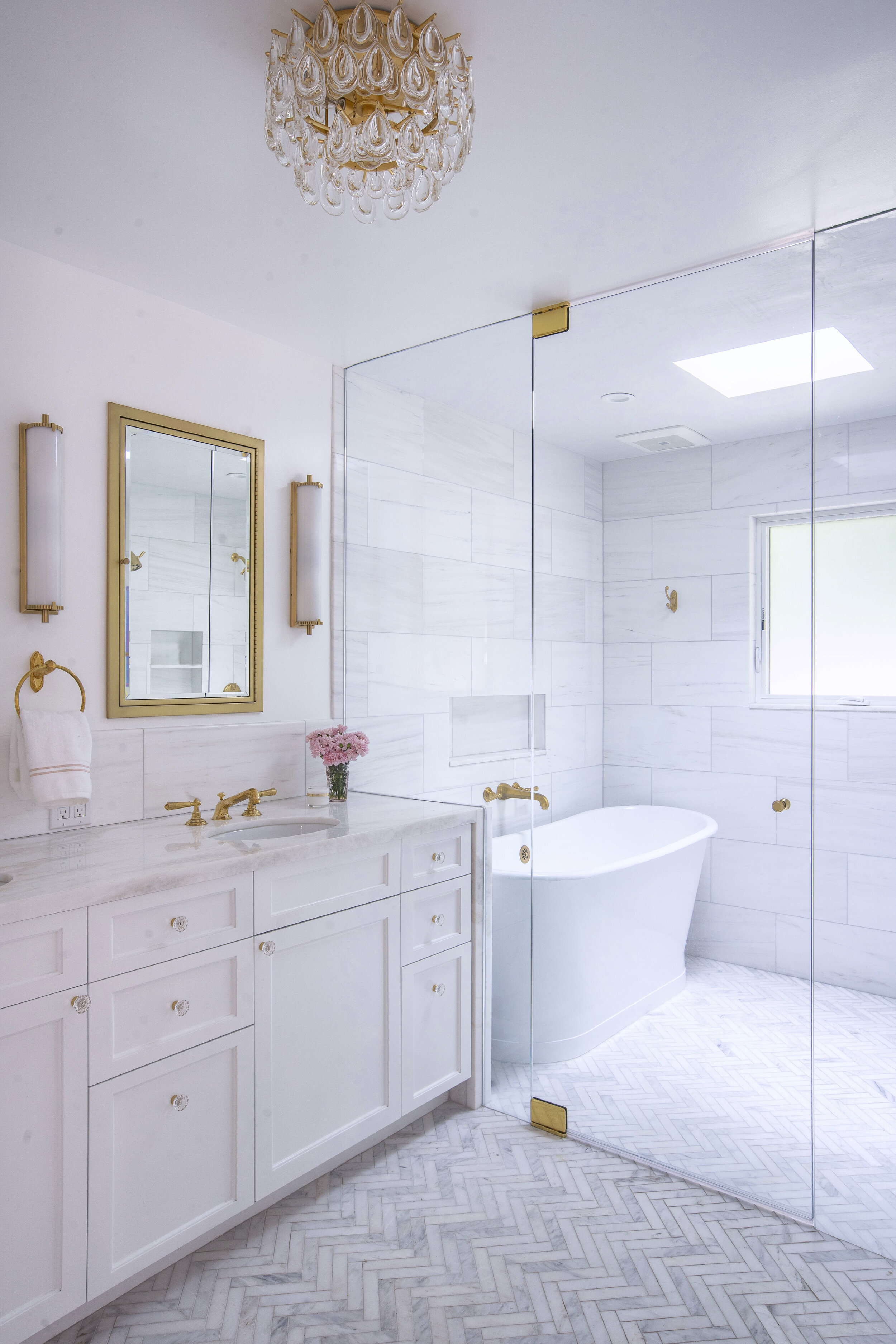 white marble bathroom brass skylight.jpg