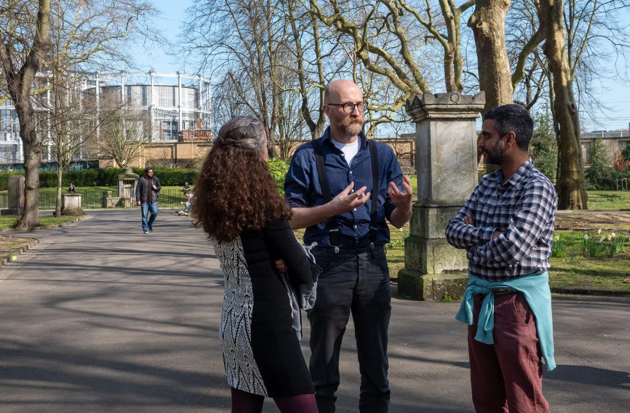 Three grantees meet outside to discuss their projects.