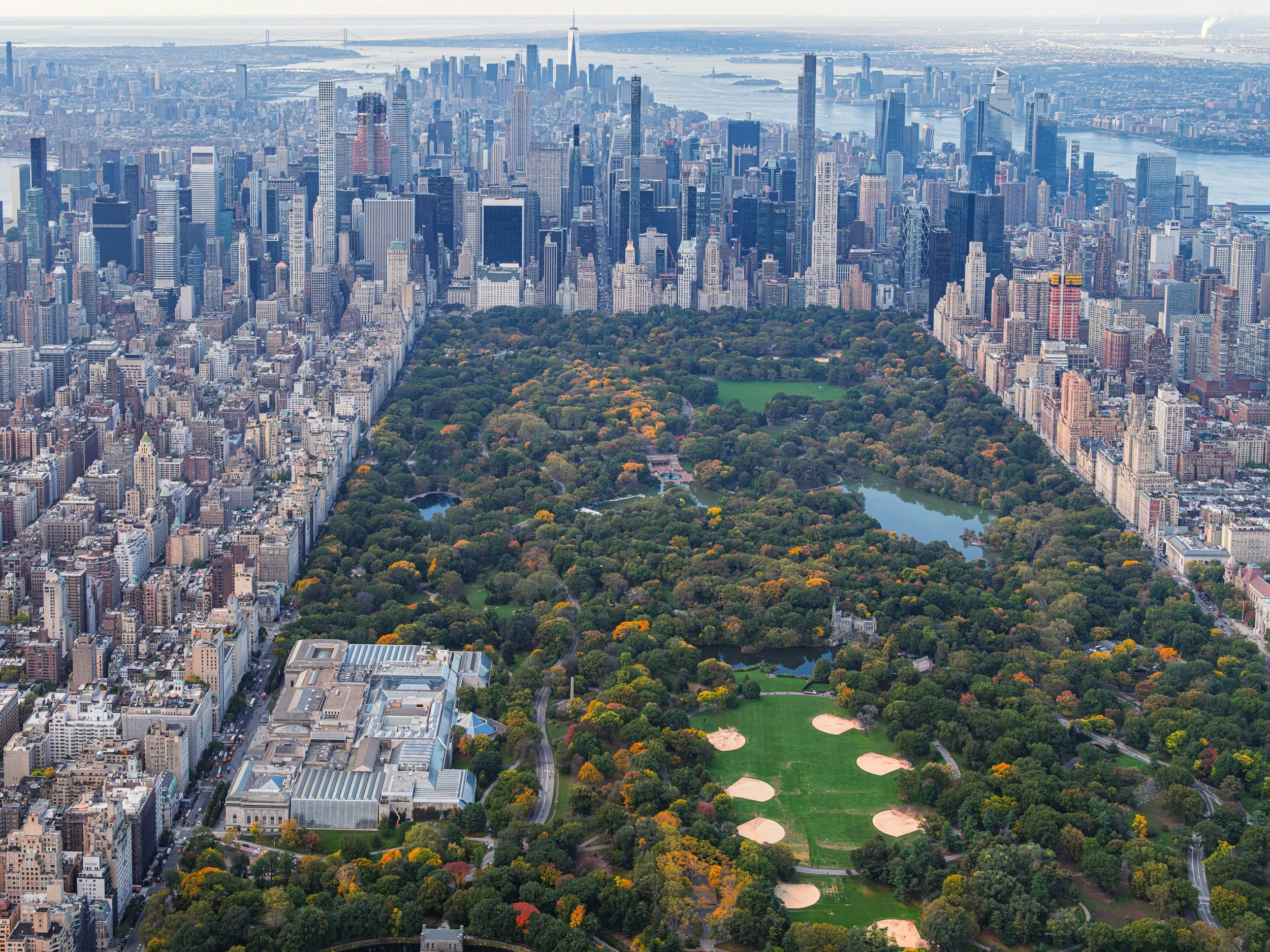 A view of Central Park surrounded by the buildings of Manhattan.