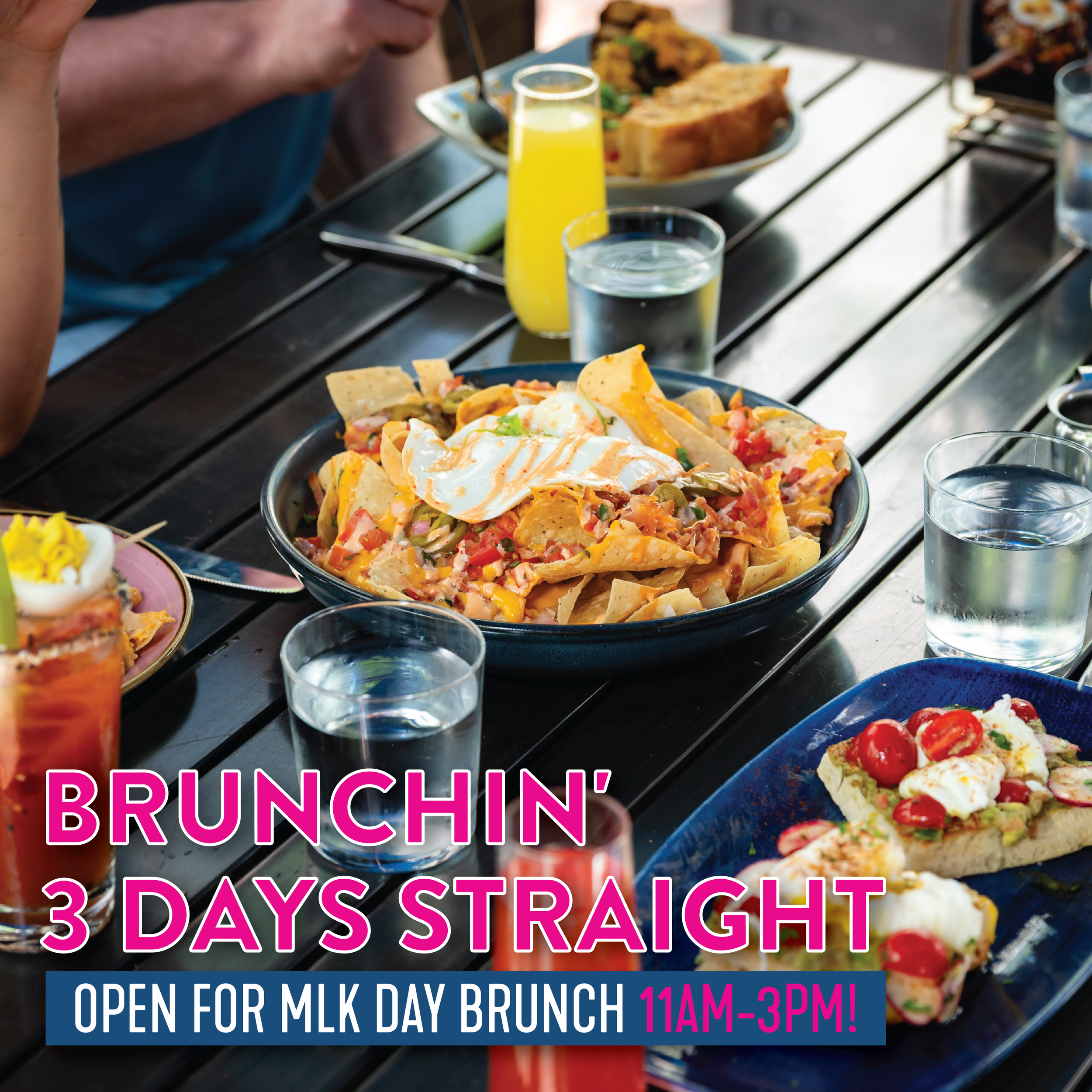 A table with brunch dishes including nachos topped with sour cream, avocado toast with tomatoes, and drinks like orange juice and water. Text reads “Brunchin’ 3 Days Straight. Open for MLK Day Brunch 11AM–3PM.