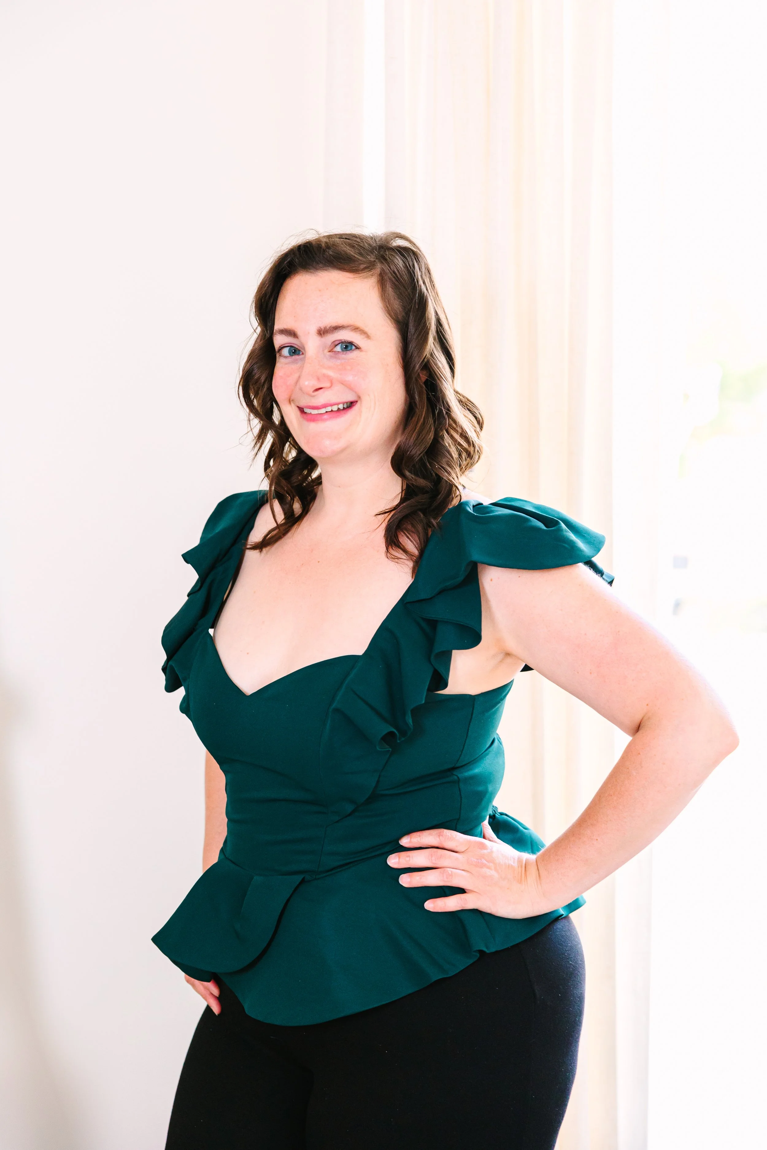 Lexi wearing a green top with hand on hip looking into camera.  - Postpartum Care Specialist, Lactation Counselor, Babywearing Educator, Child Passenger Safety Technicial, Craniosacral Therapist - Cleveland, Ohio