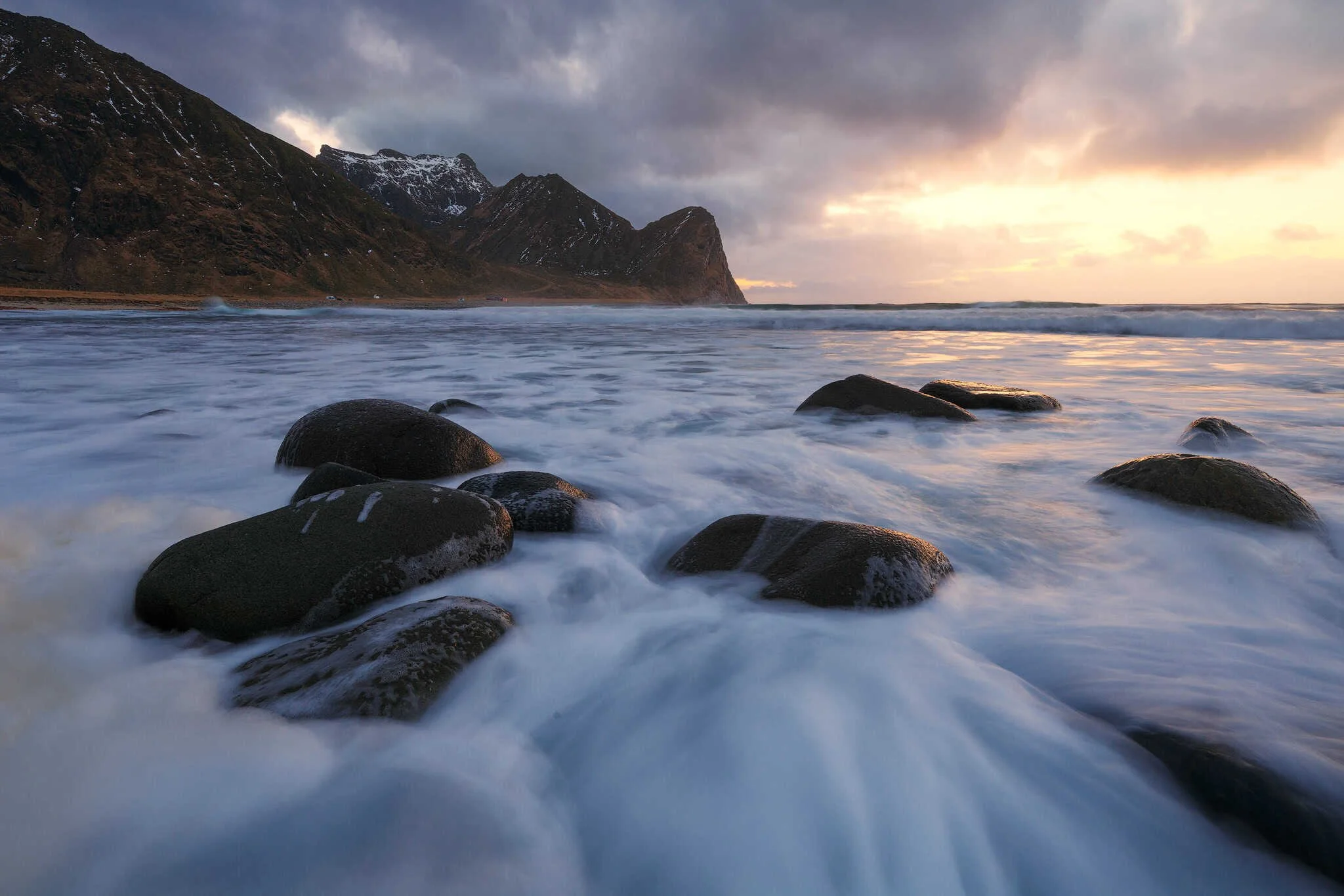 Enclosed bay framed by mountains at Unstad Beach in winter, Lofoten, Norway
