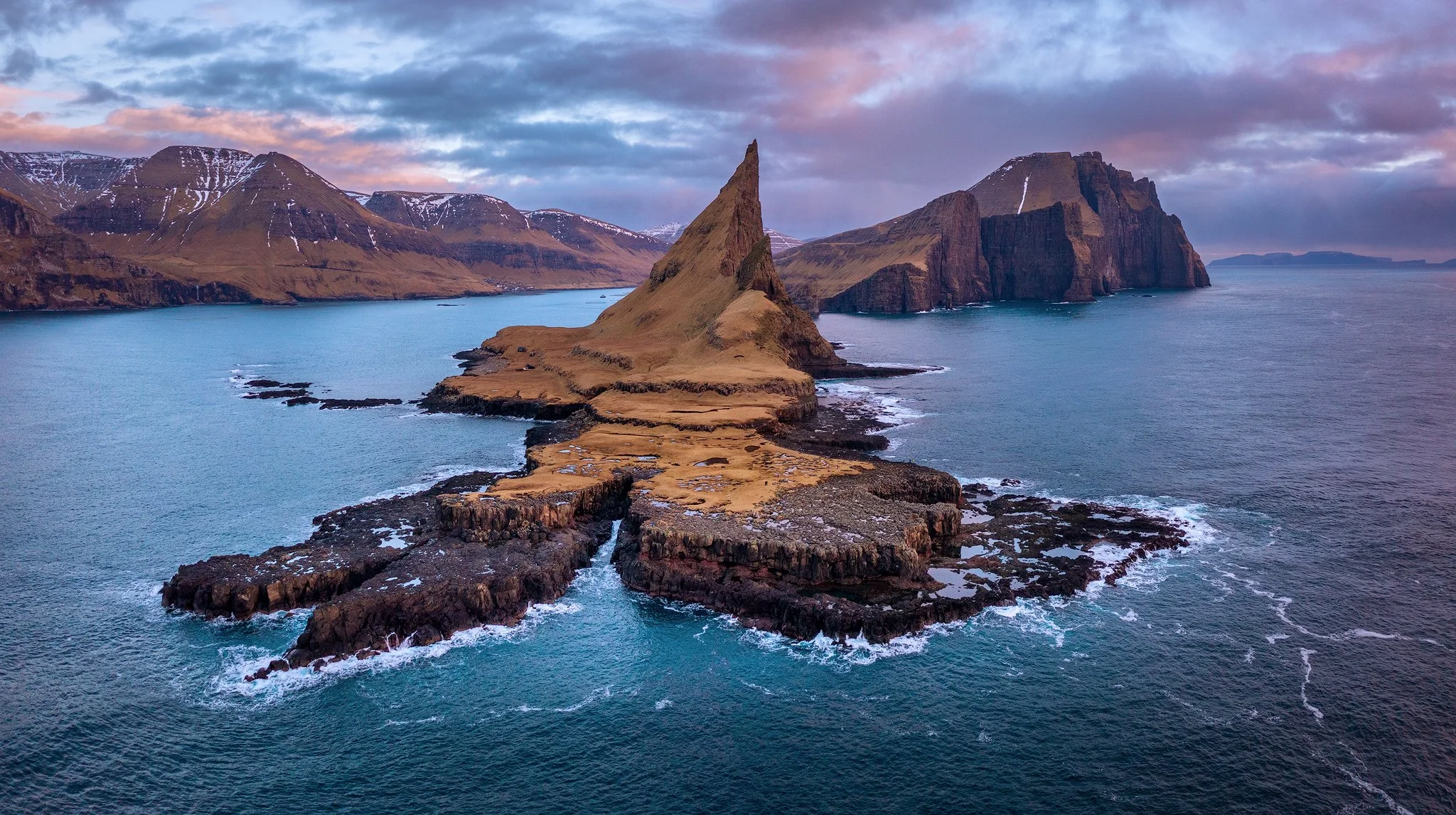 Aerial drone panorama over Tindhólmur and the surrounding cliffs and sea, Faroe Islands