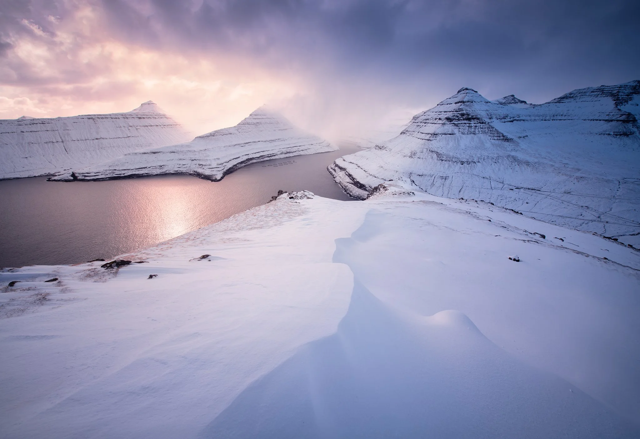 Snow-covered peaks at sunrise above Funningur fjord, Faroe Islands
