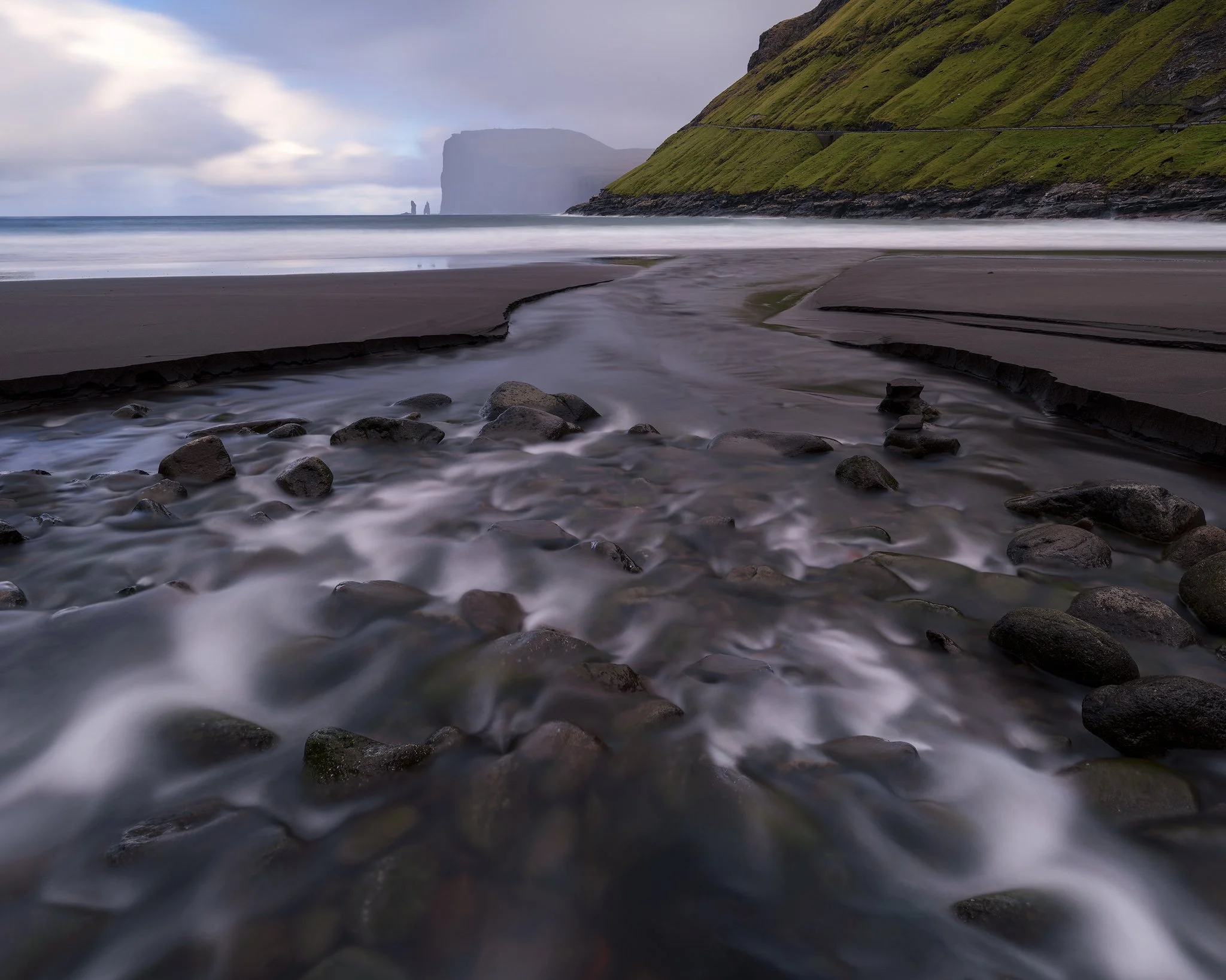 Long exposure seascape at Tjørnuvík beach with the Risin og Kellingin sea stacks in the distance, Faroe Islands