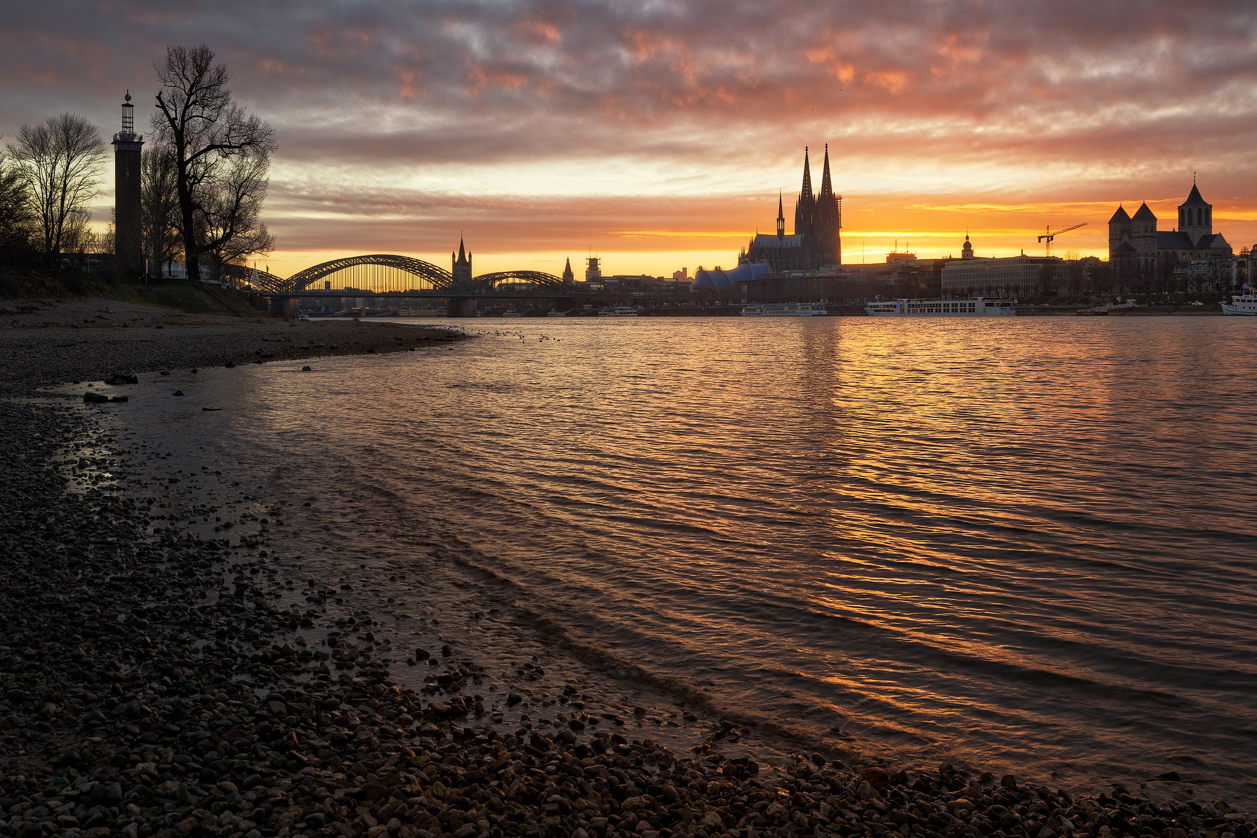 Beautiful late glow after sunset above the Altstadt of Köln (Cologne) in Germany shot from the Rhein river shore by Felix Inden