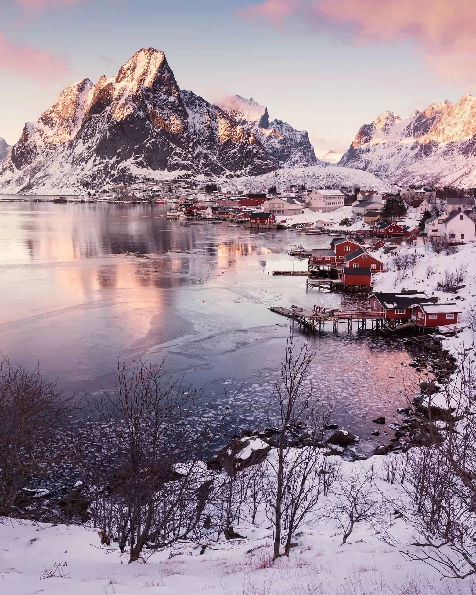 Layered fjord scene with steep peaks and reflections in Reine in winter, Lofoten, Norway