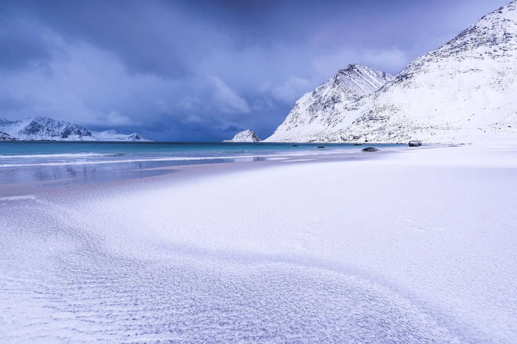 Snow-capped mountains above Haukland Beach in winter, Lofoten, Norway