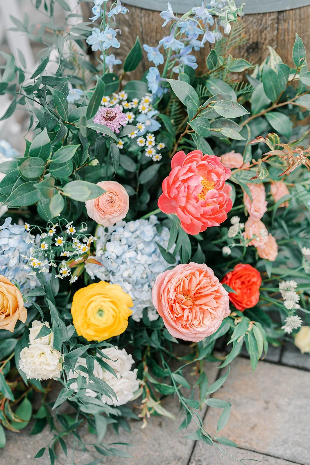 Colorful bouquet of various flowers including roses, peonies, hydrangeas, daisies, and greenery.