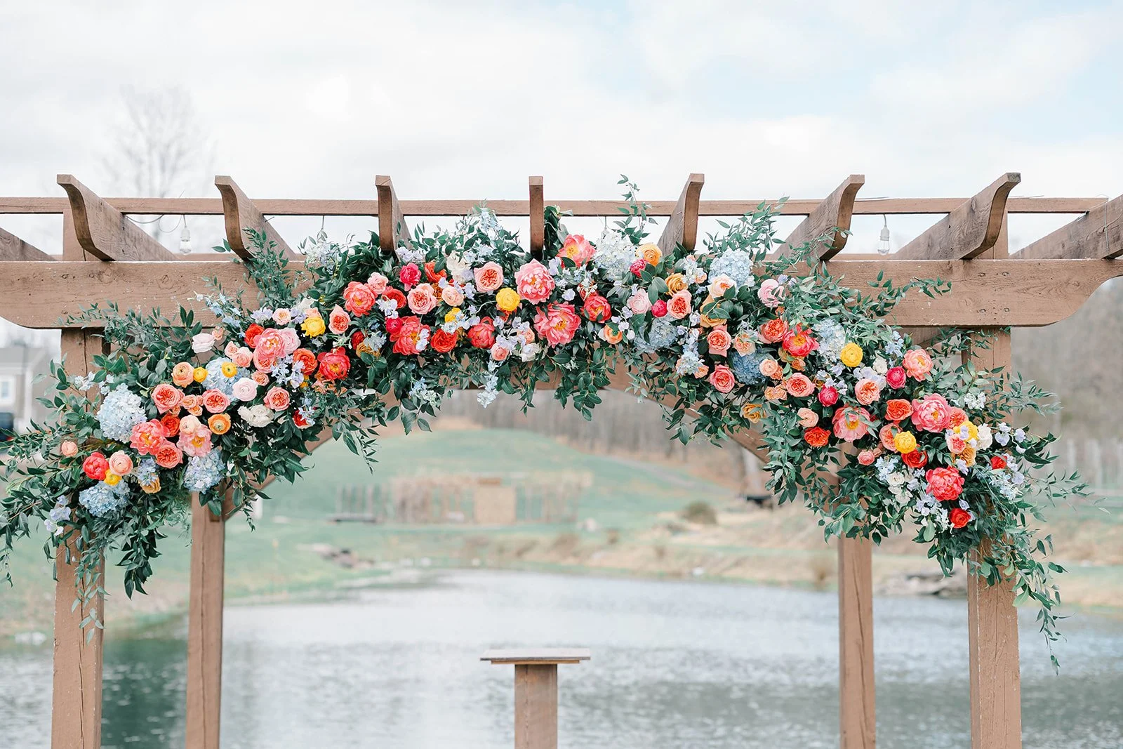 Spring wedding flowers at Bear Brook Valley in New Jersey featuring colorful floral design with peonies, daffodils, and sweet pea