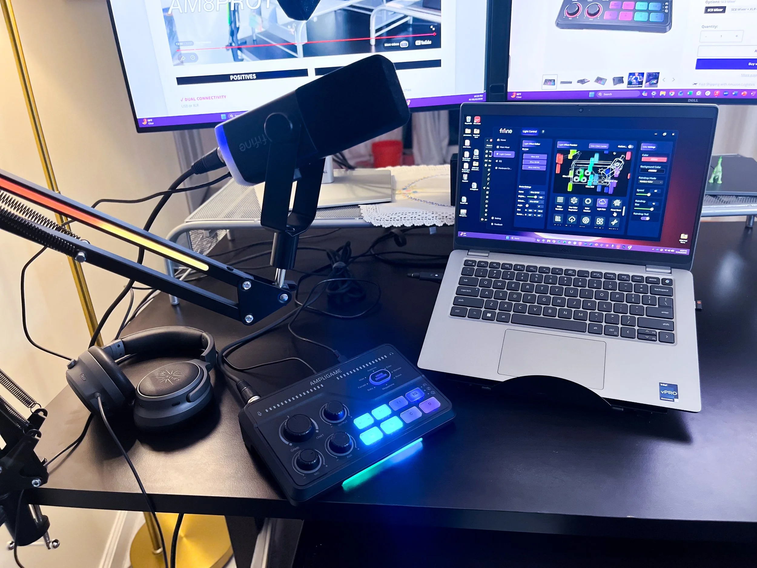 Image of a FIFINE microphone, laptop and mixer on a desk in a review by The Sypnotix