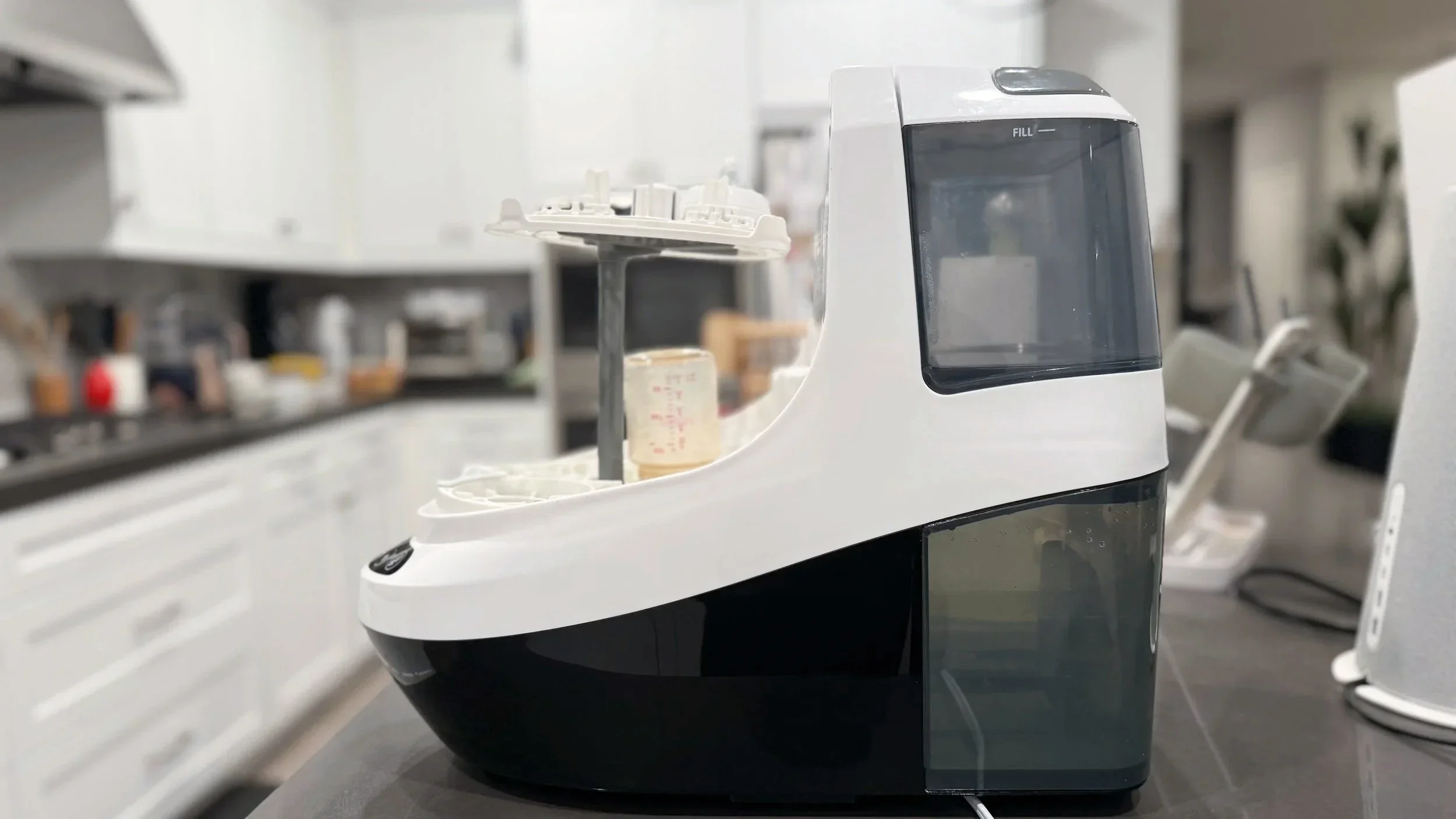 Image of the original Baby Brezza Bottle Washer Pro on a counter being loaded