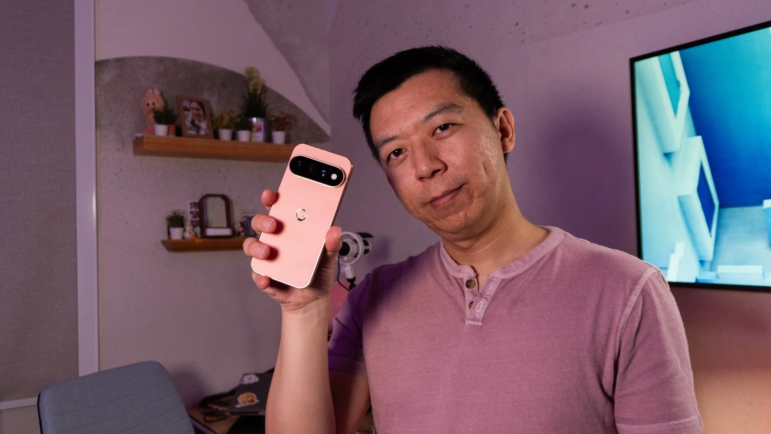An image of Alex, a reviewer at The Sypnotix, holding the Google Pixel 11 Pro in a review