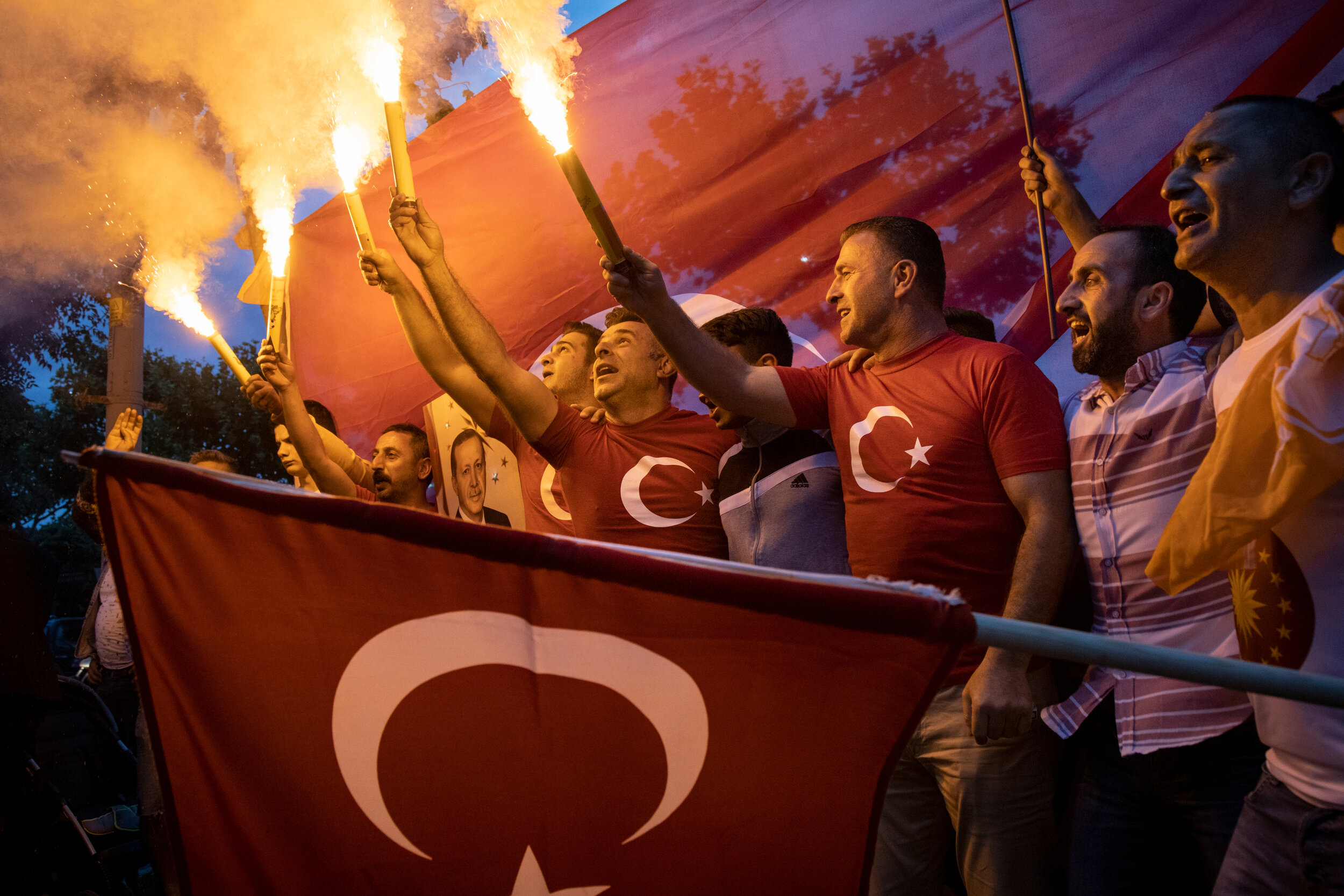  Supporters of Turkey's Justice and Development Party (AKP) react to preliminary election results at the party's headquarters in Istanbul, Turkey, on Sunday, June 24, 2018. 