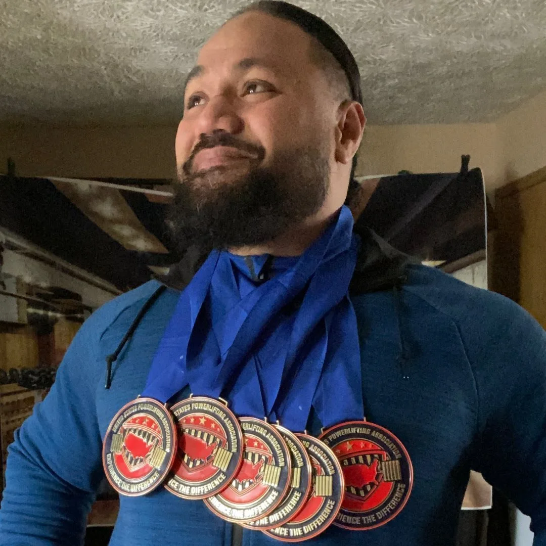 Southside champion powerlifter Tipasa Faletagoi displaying multiple competition medals.