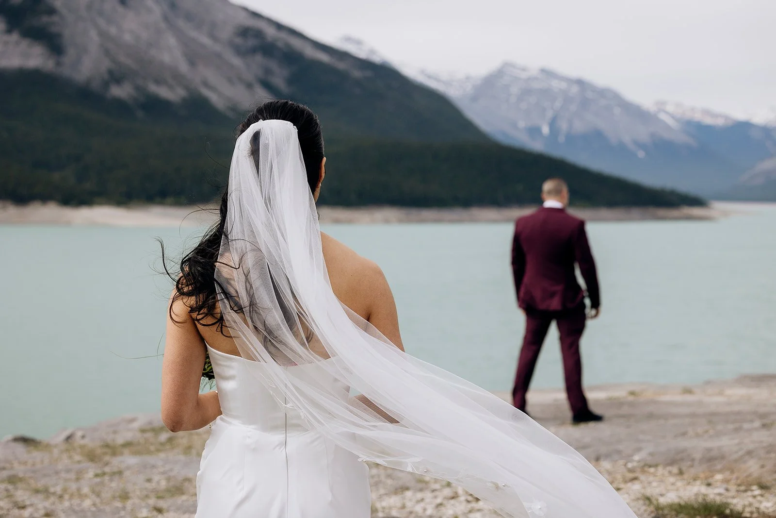first-look-at-abaraham-lake-before-their-heli-elopement-on-a-dramatic-cliff-in-banff-with-Wild-Alpine-Image-Co.-Banff's-best-elopement-photographers