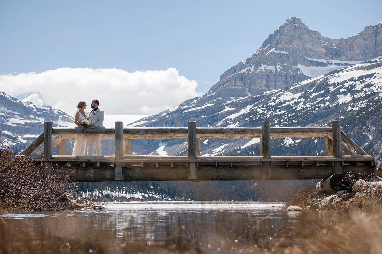 wedding-photos-on-the-bridge-at-bow-lake-with-Wild-Alpine-Image-Co.-Banff's-bespoke-elopement-experts