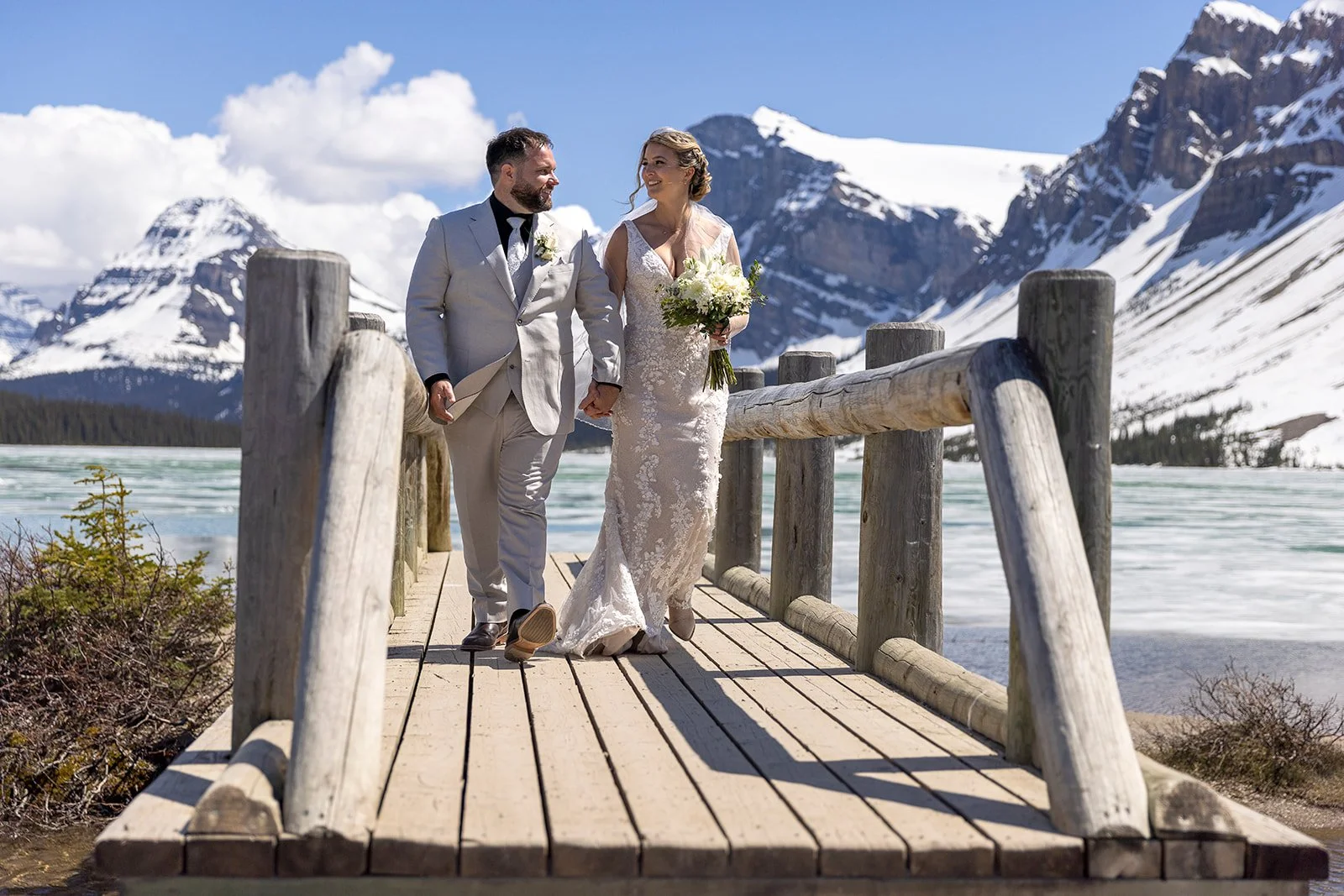 wedding-photos-on-the-bridge-at-bow-lake-with-Wild-Alpine-Image-Co.-Banff's-bespoke-elopement-experts