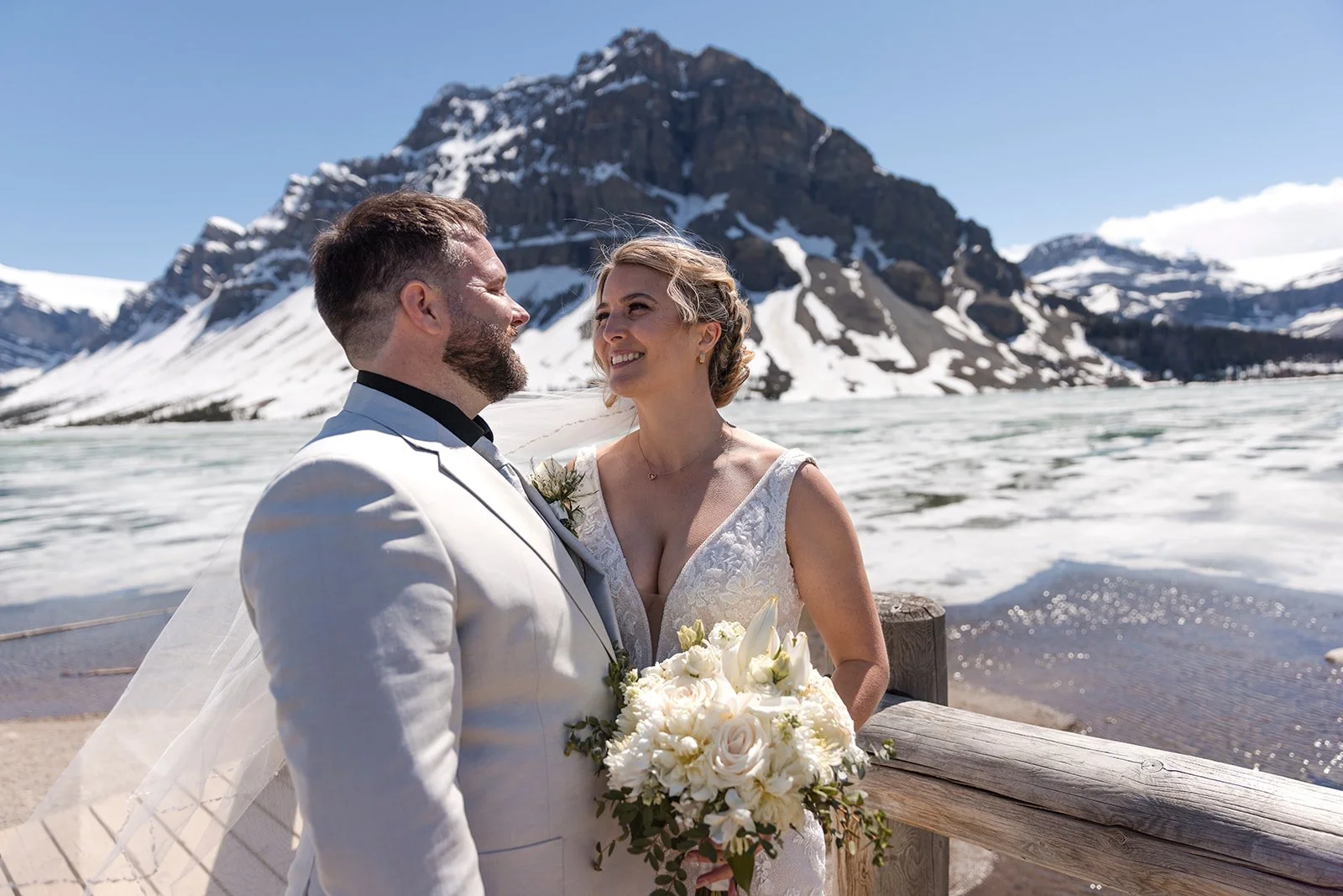 wedding-photos-on-the-bridge-at-bow-lake-with-Wild-Alpine-Image-Co.-Banff's-bespoke-elopement-experts