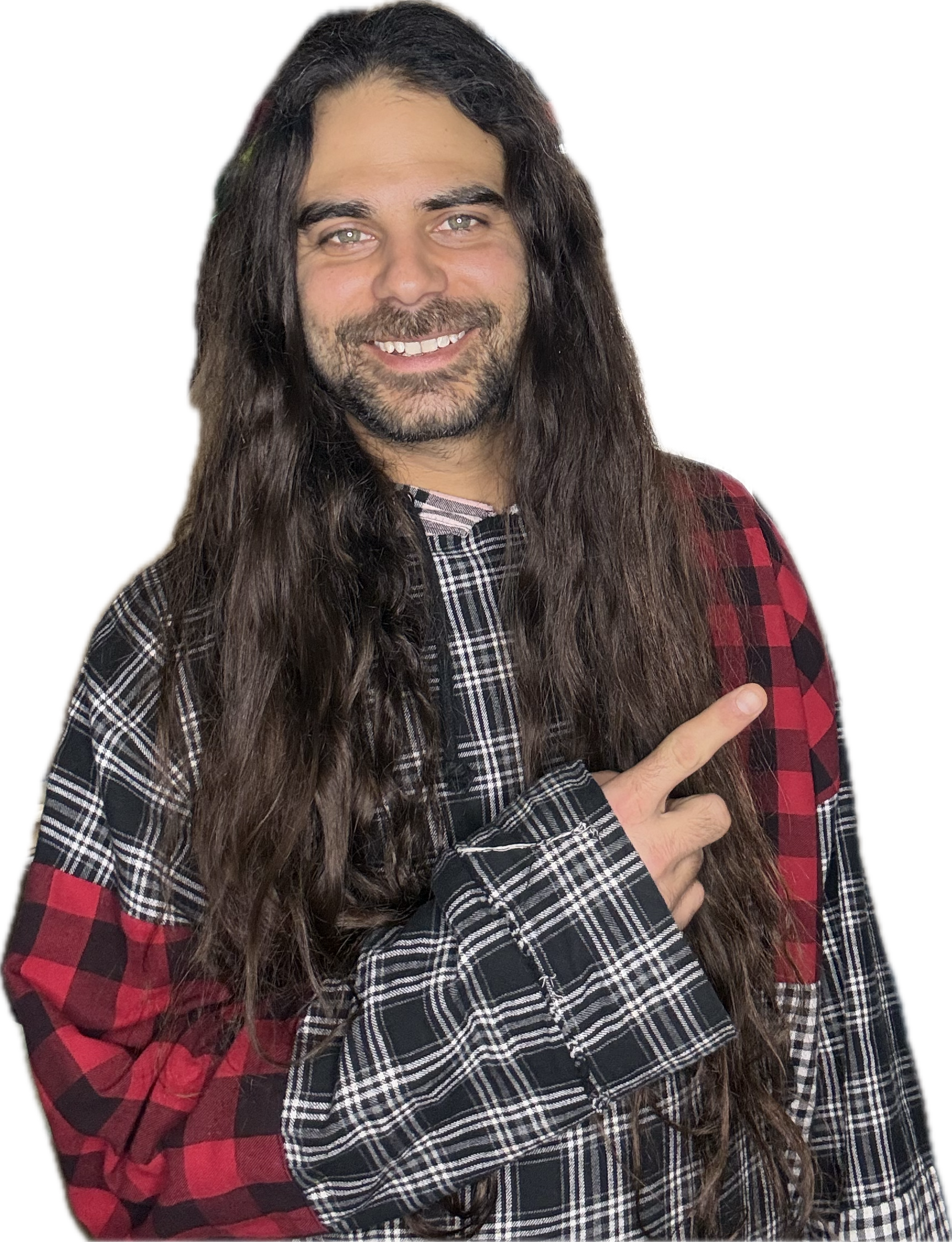 Man with long dark hair, a beard, and light skin wearing a plaid shirt, smiling, pointing with his right hand.