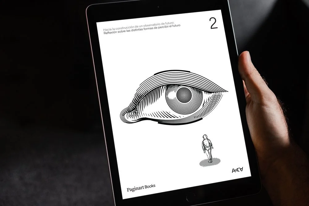A tablet displaying a black-and-white illustration of an eye with a labyrinth pattern inside it, and a small human figure below the eye. Text in Spanish at the top references constructing a future observatory and contemplating different ways of perceiving the future.