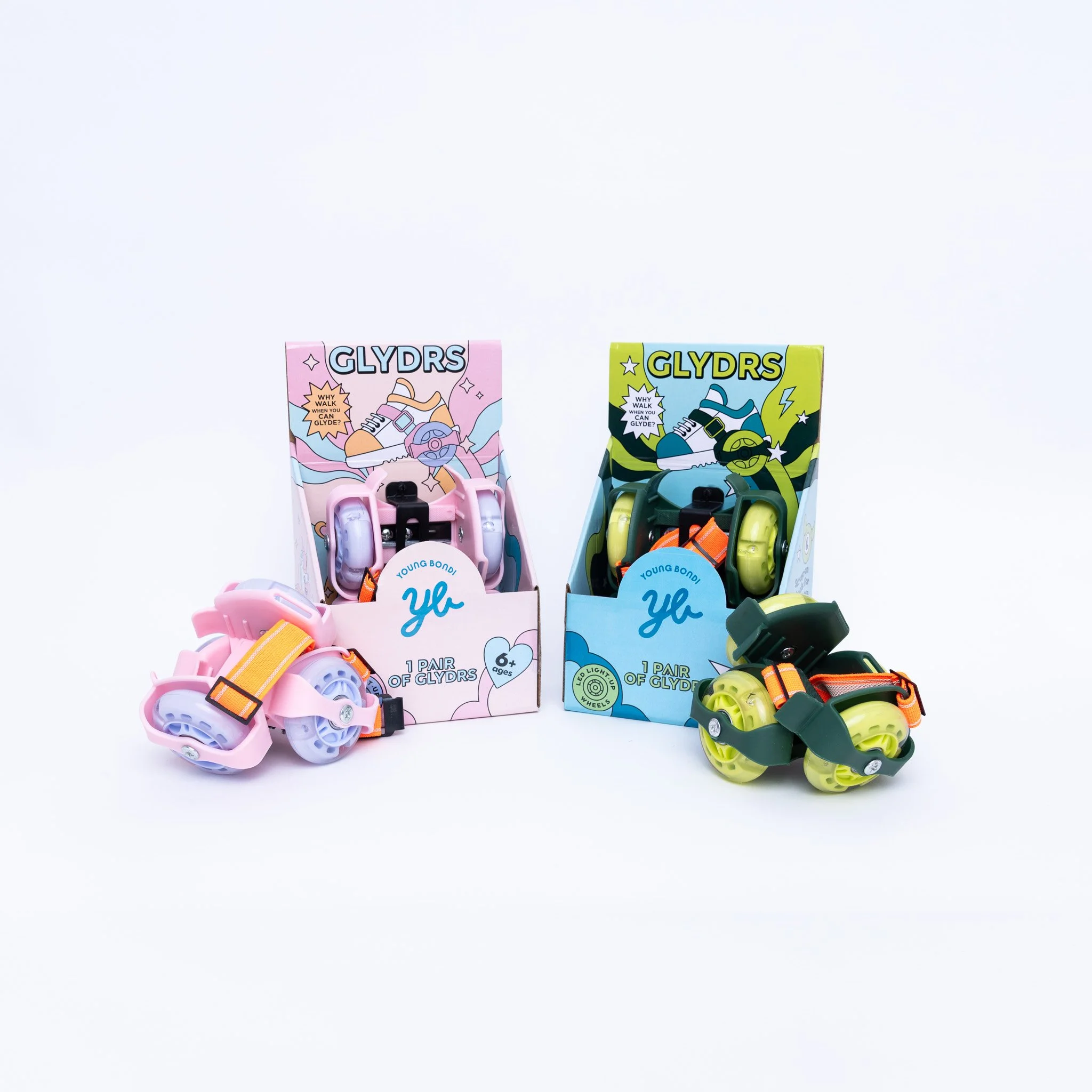 Colorful adjustable roller skates in pink and green, displayed on boxes with cartoon graphics and packaging for young children.