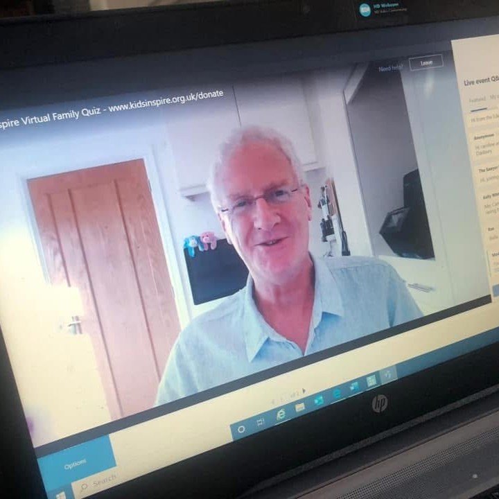  Laptop screen showing Dave, dressed in a pale blue shirt and seated in front of the screen, hosting the online Kids Inspire Virtual Quiz during lockdown 