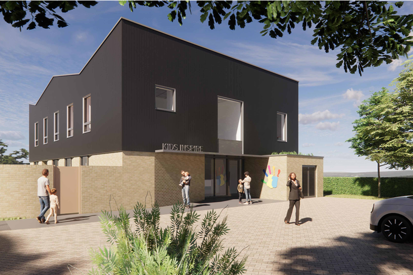 Modern building with lots of windows and Kids Inspire coloured hand logo on the wall. Children and families are gathered outside.