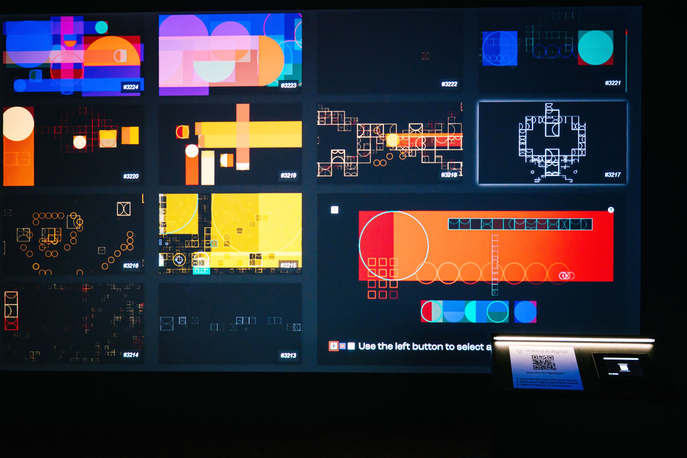Gallery installation view of shemza.digital #8, showing the evolving archive of collaboratively created digital paintings projected in real time.