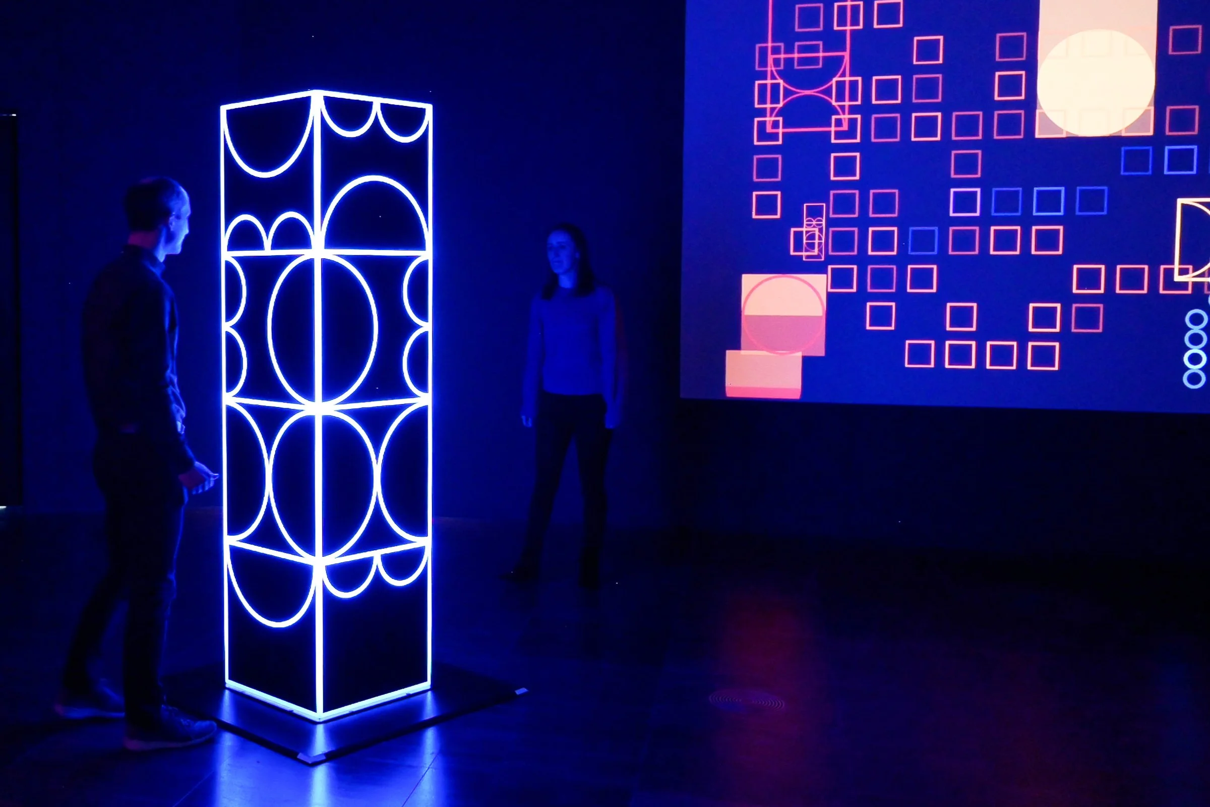 Visitors interacting with shemza.digital #6, an interactive light sculpture that responds to movement through changing illumination.