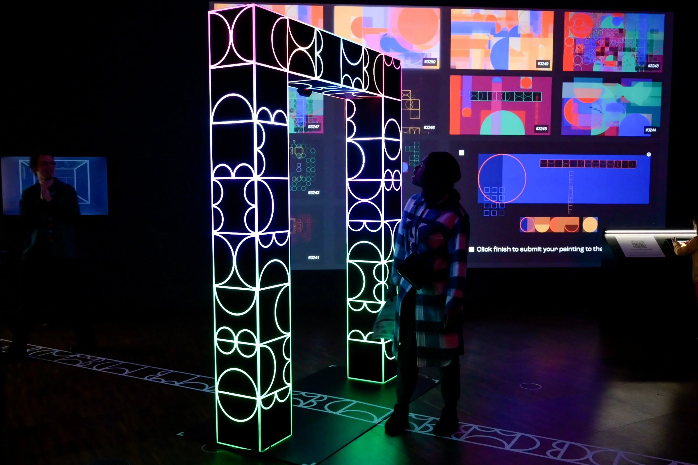 Visitor interacting with shemza.digital #5, walking through the interactive illuminated archway.
