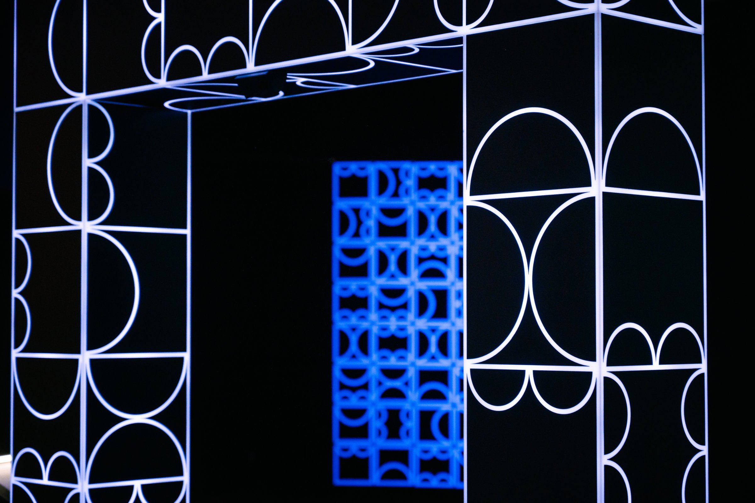 Close-up detail of shemza.digital #5, showing the illuminated recycled acrylic geometric forms.