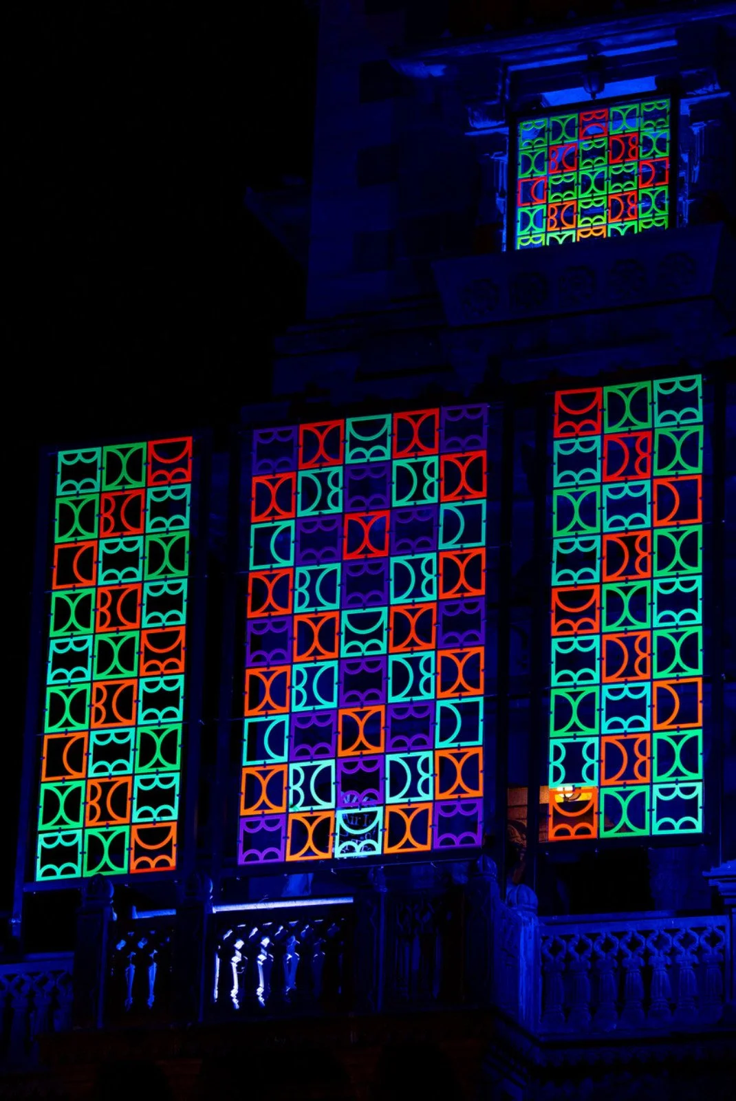 Close-up of fluorescent geometric forms from shemza.digital #17, illuminated by ultraviolet light and inspired by Indo-Islamic architecture.