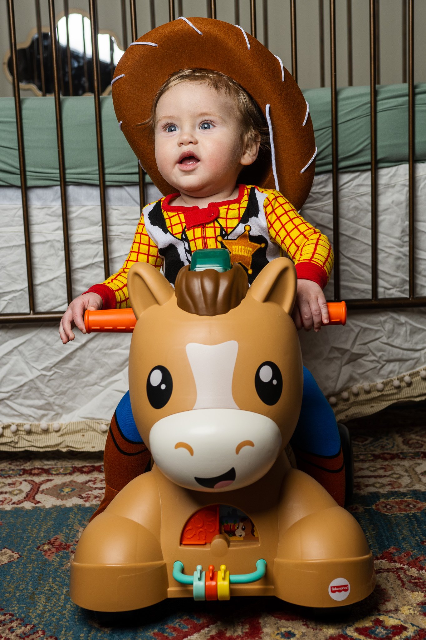 Baby Dressed As Cowboy On Toy Horse