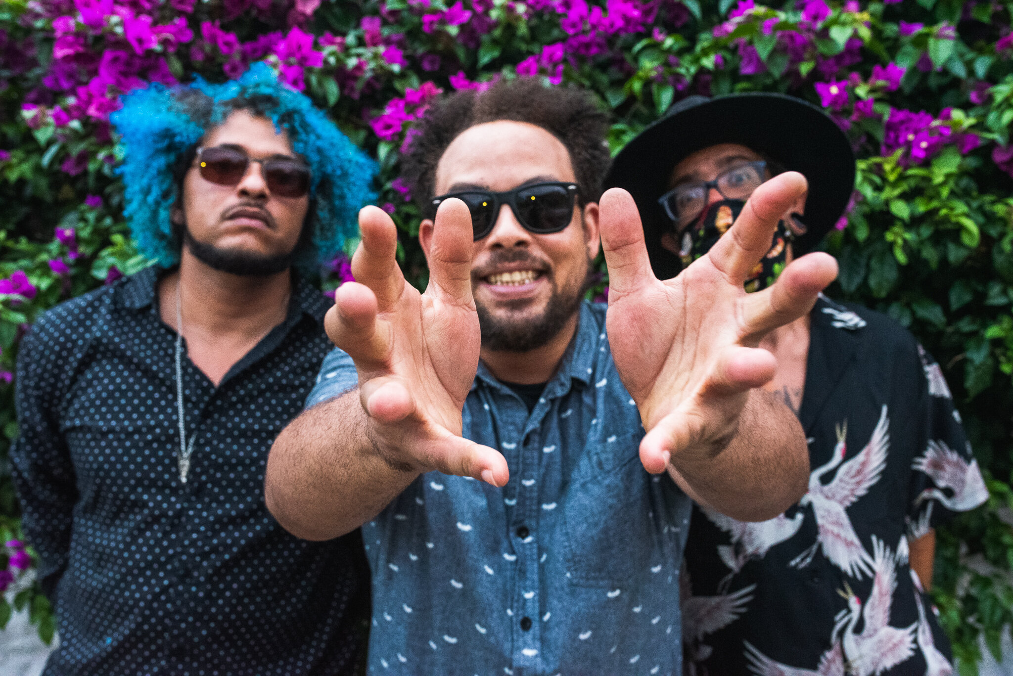 Three Men One With Hands Outstretched