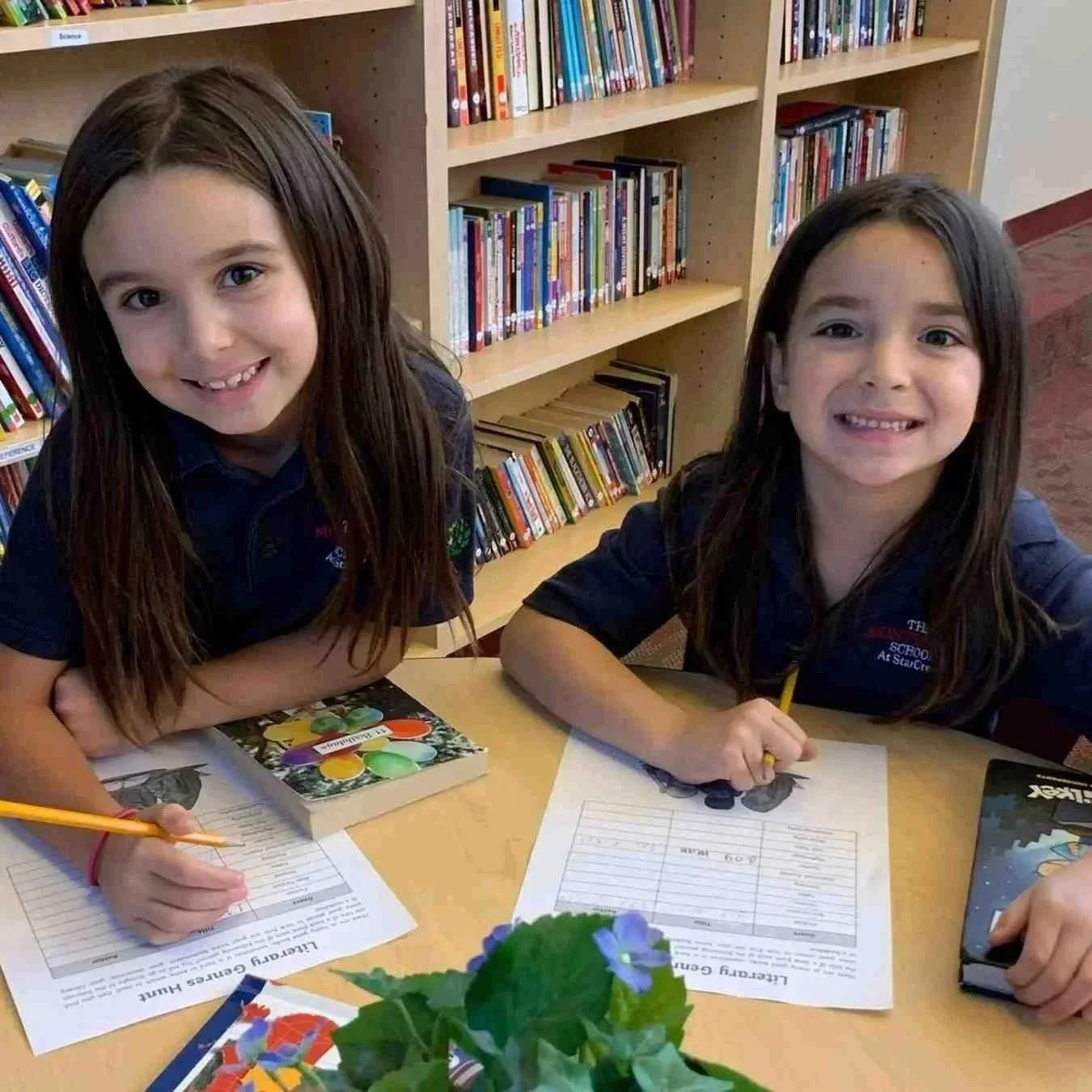 Two Montessori students participated in a learning activity in the library of Allen, TX.
