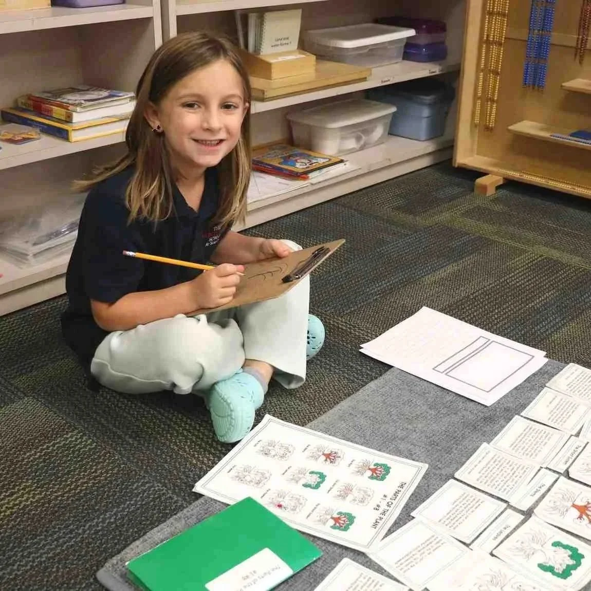 Elementary level Montessori student working independently with learning materials in Allen, TX
